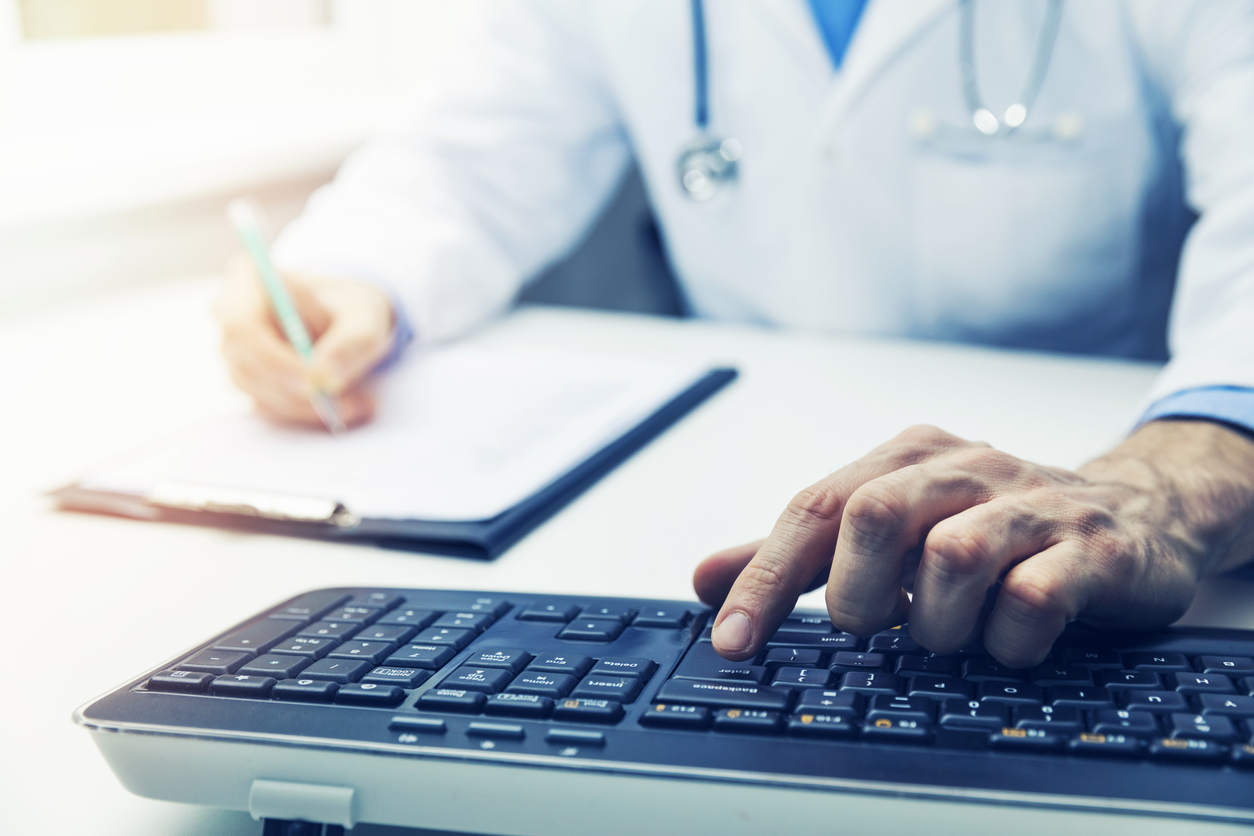 doctor working on computer in clinic office